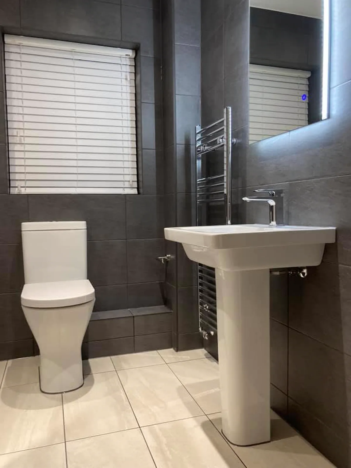 Finished dark tiled bathroom