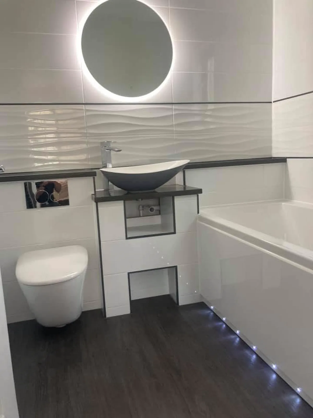 White bathroom with a modern illuminated mirror