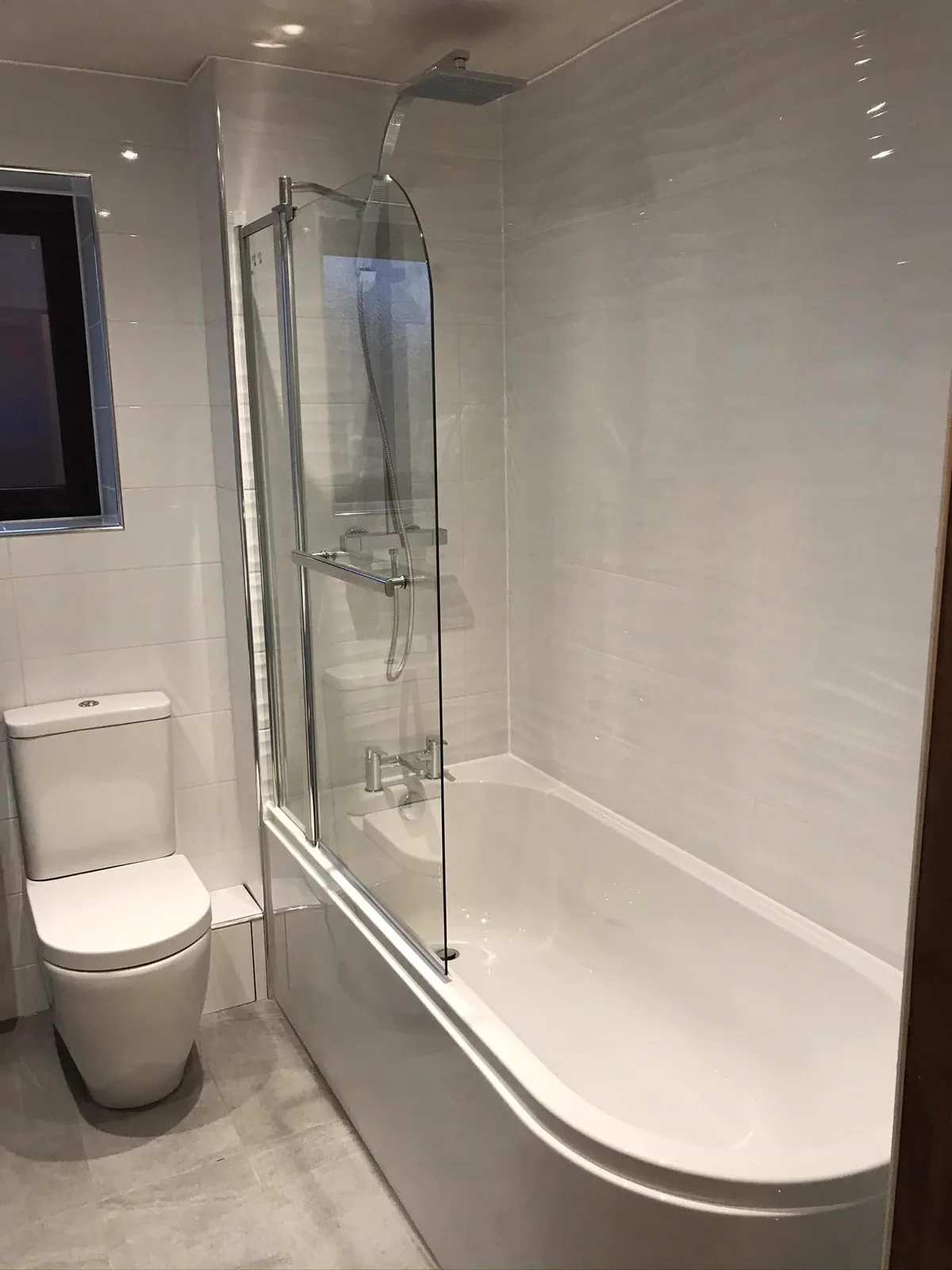 White bathroom suite with shower bath